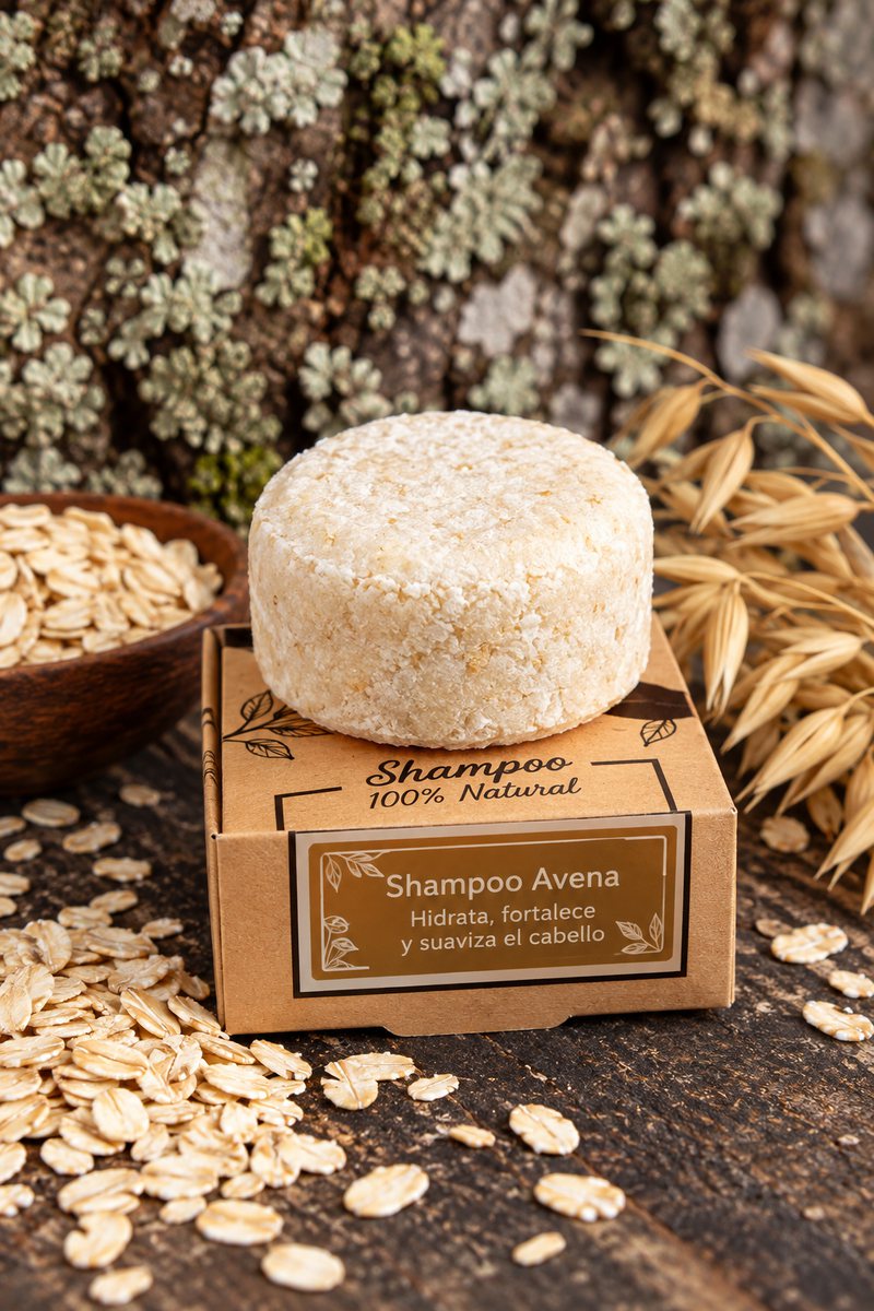 Shampoo sólido de avena sobre su caja kraft, junto a hojuelas y espigas de avena